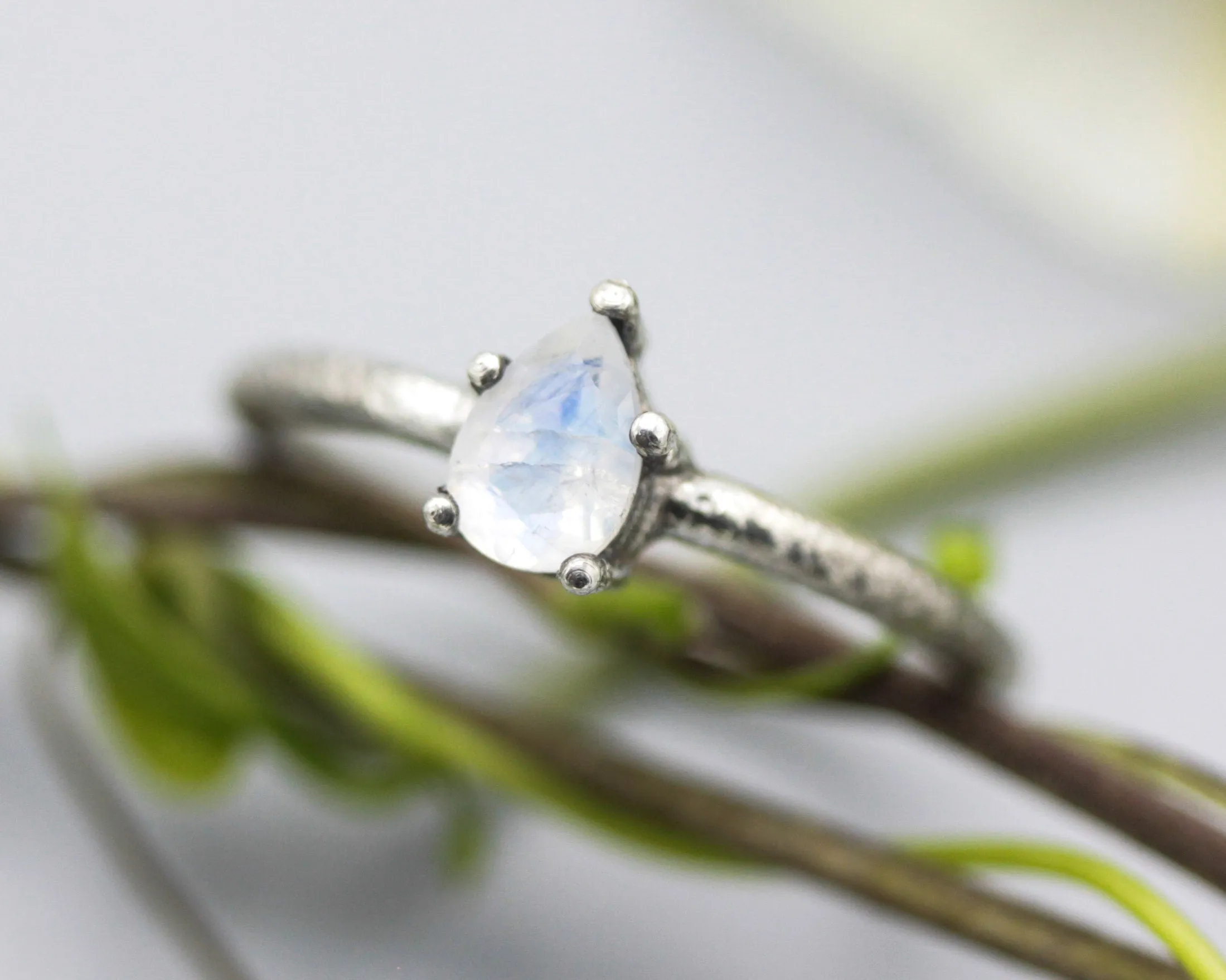 Teardrop faceted Moonstone ring in prongs setting with sterling silver oxidized texture band