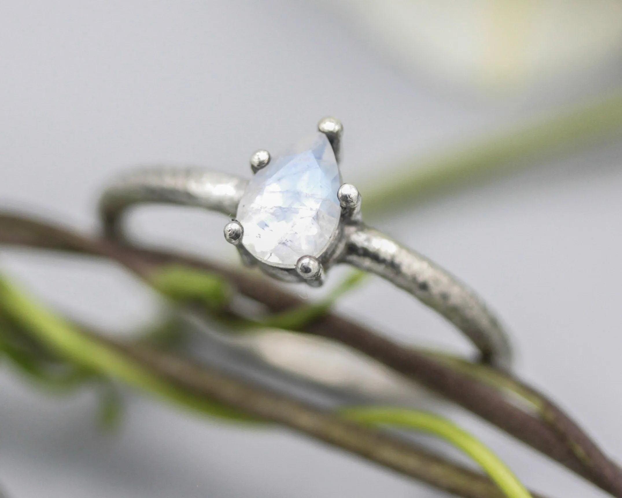 Teardrop faceted Moonstone ring in prongs setting with sterling silver oxidized texture band